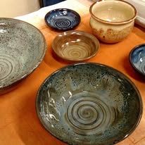Collection of hand-thrown bowls in teal, speckled, and earth-tone glazes