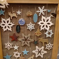 Finished holiday ornaments hanging on a display rack