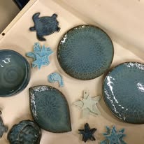 Ocean-inspired blue teal plates, turtles, and starfish pieces